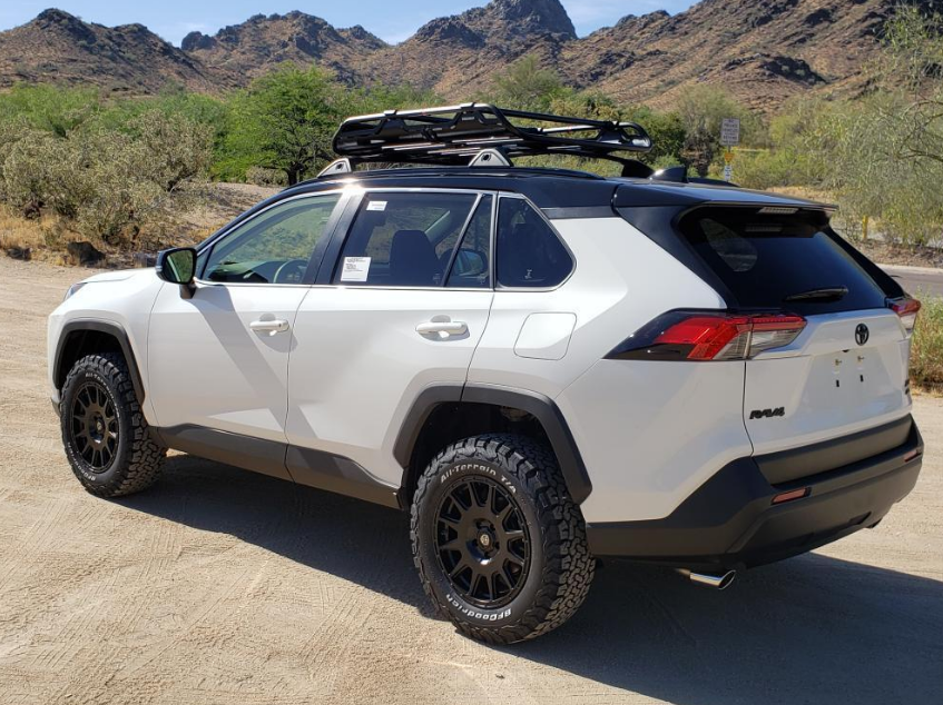 lifted white rav4 with mountains
