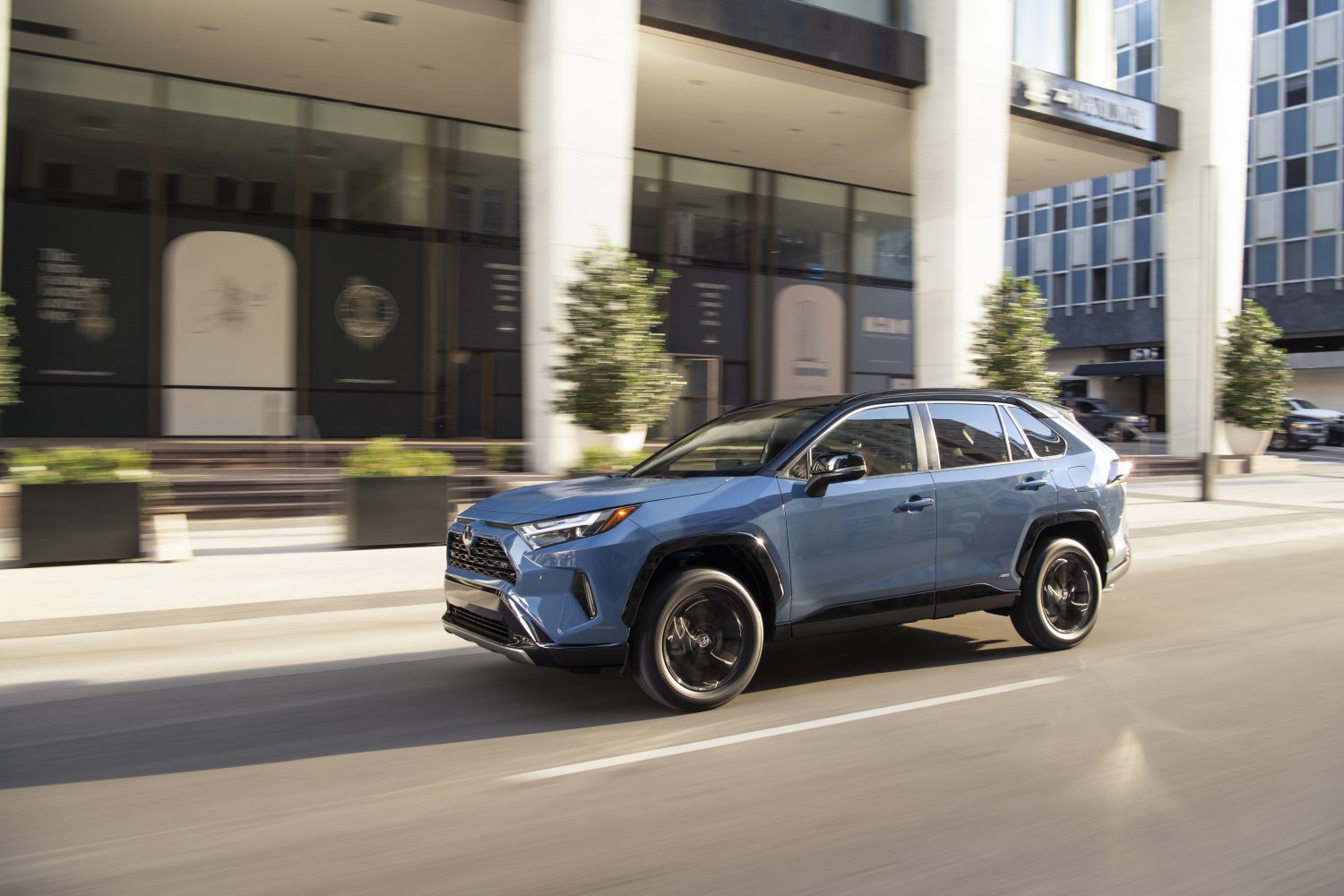 rav4 in cavalry blue front left view driving on road