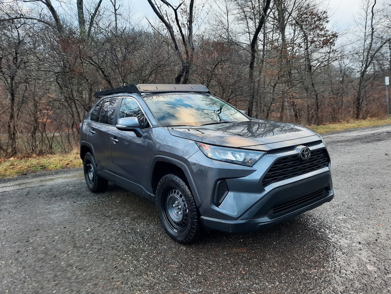 magnetic gray metallic rav4 front right view in rainy weather