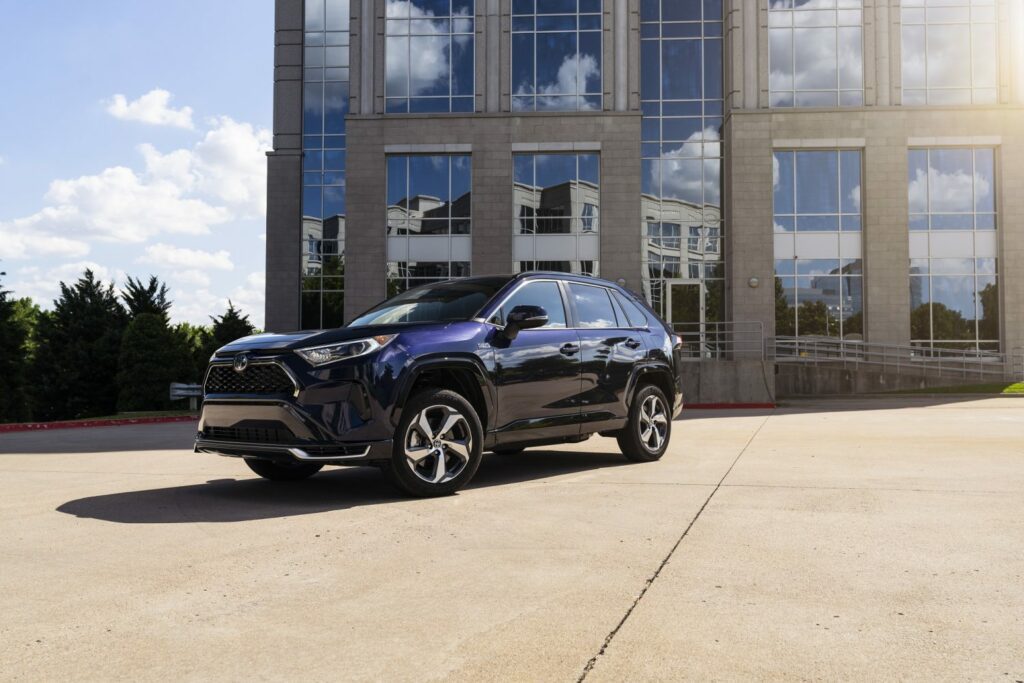 front left low-profile view of blueprint rav4 with building in background