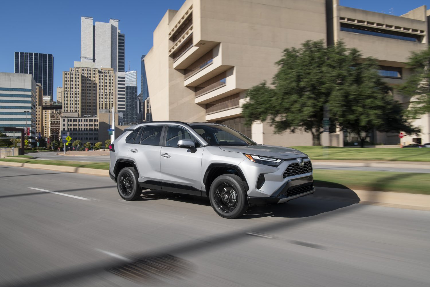 silver sky metallic toyota rav4 front right view in city driving