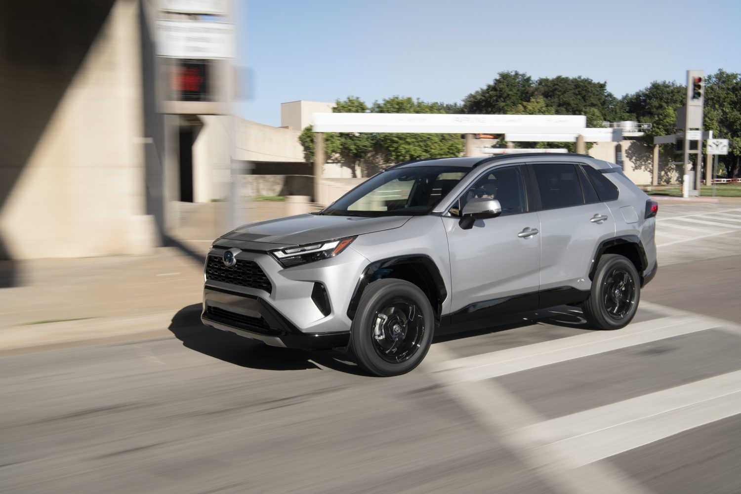 silver sky metallic toyota rav4 front left view in city driving