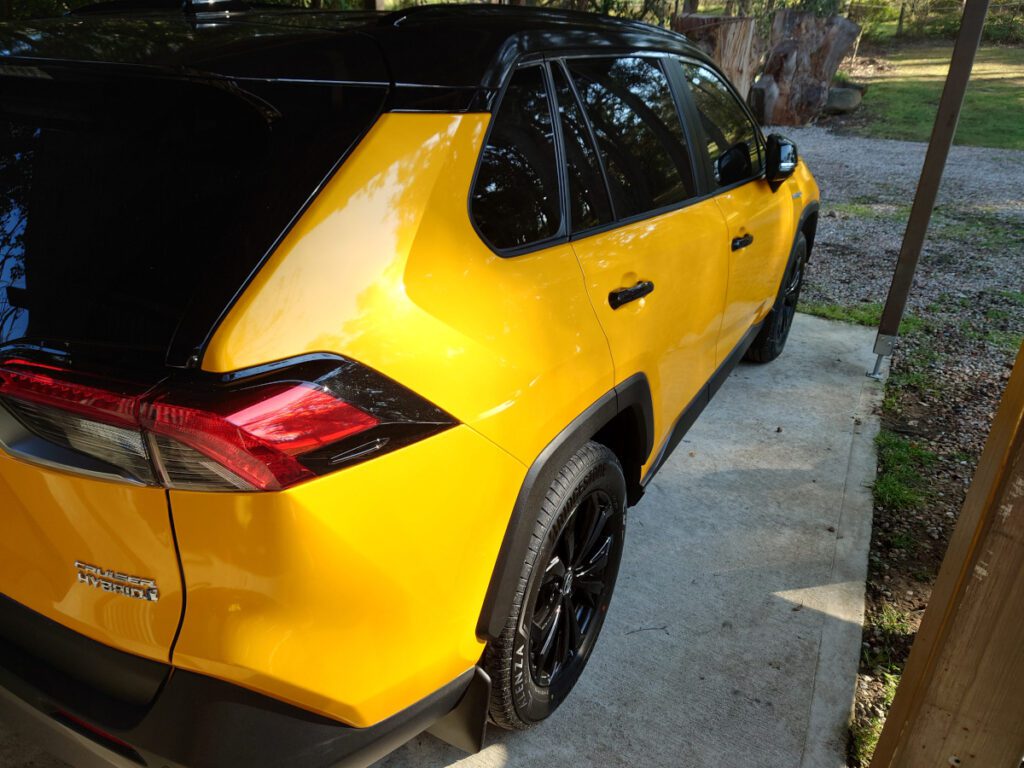 yellow toyota rav4 right side view from rear