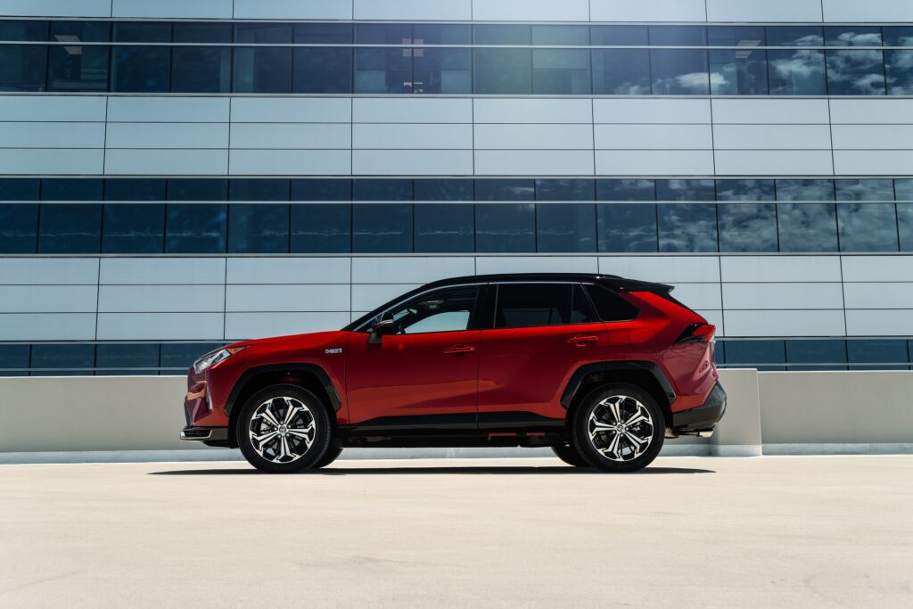 2024 Toyota RAV4 Prime in Supersonic Red, side angle.